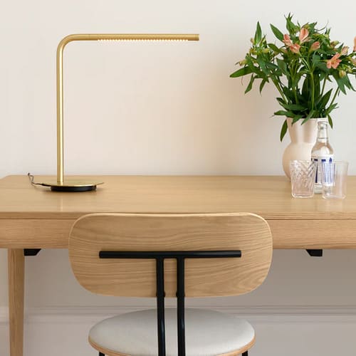 Lampe de table en laiton brossé multifonctionnelle avec un éclairage à 360° degrés.